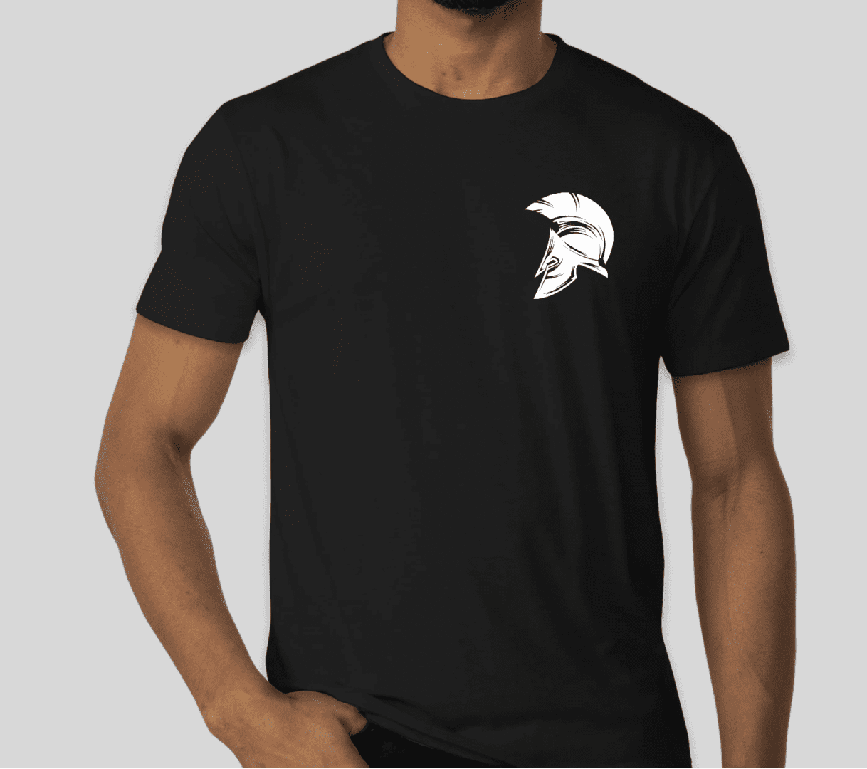 Man wearing a black Crest Tee with a white spartan helmet graphic.